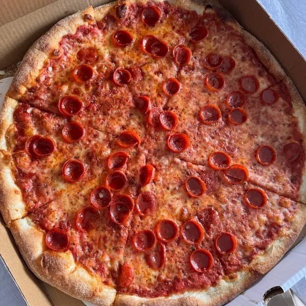 A whole pepperoni pizza from Tony's Pizzeria, sliced and ready to eat in a cardboard box.