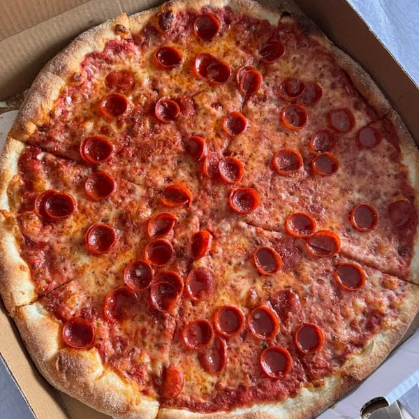 A whole pepperoni pizza from Tony's Pizzeria in a cardboard box, with a golden crust.